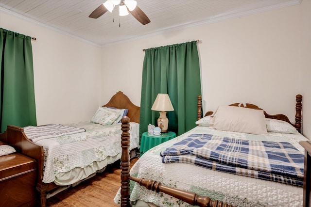 bedroom featuring hardwood / wood-style floors, ceiling fan, and ornamental molding