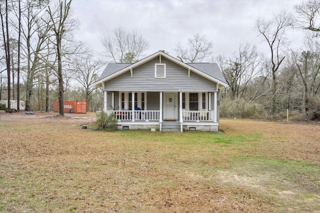 view of front of home with covered porch and a front yard