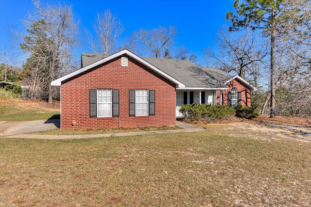 view of front of property with brick siding and a front lawn