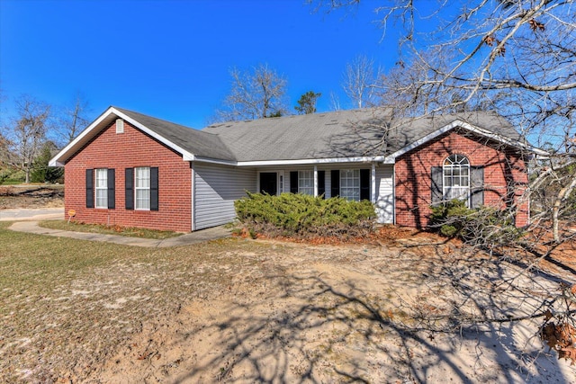 ranch-style home featuring brick siding