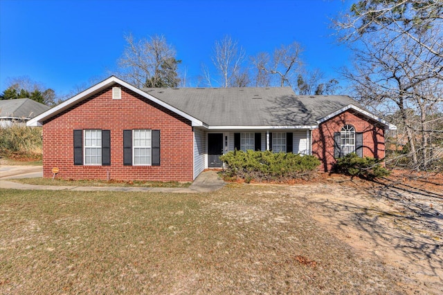 ranch-style home with brick siding and a front lawn