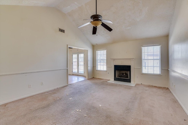 unfurnished living room with a fireplace with flush hearth, visible vents, and carpet flooring