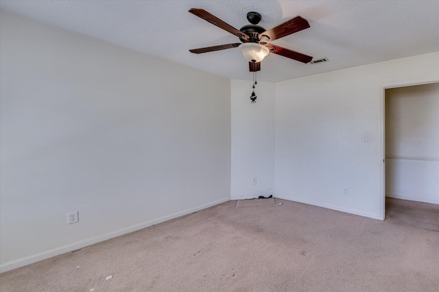 spare room with carpet, visible vents, ceiling fan, a textured ceiling, and baseboards