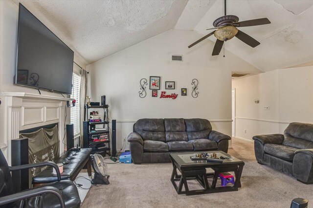 carpeted living room featuring lofted ceiling, visible vents, a fireplace, and a textured ceiling