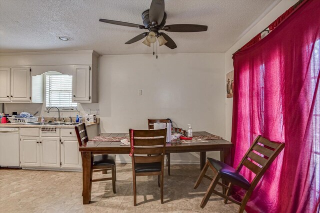 dining area with a textured ceiling and a ceiling fan