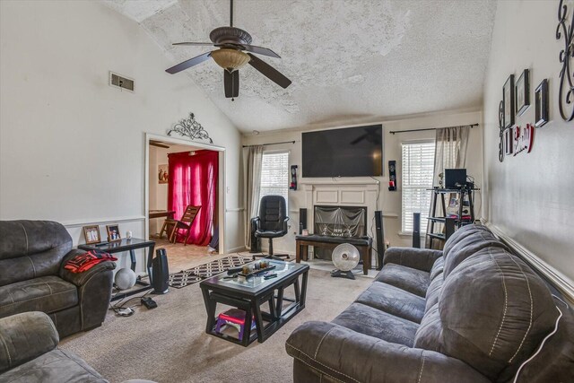 carpeted living area featuring vaulted ceiling, a textured ceiling, plenty of natural light, and a fireplace