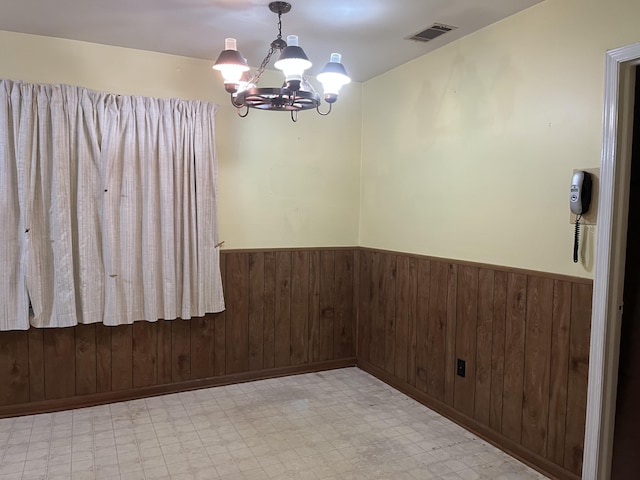 3323 Young Forest Dr, Augusta, GA 30906 - empty room featuring tile patterned floors, a wainscoted wall, a chandelier, and wood walls