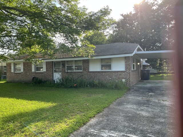 3323 Young Forest Dr, Augusta, GA 30906 - view of front of house with concrete driveway, brick siding, a front yard, and a carport