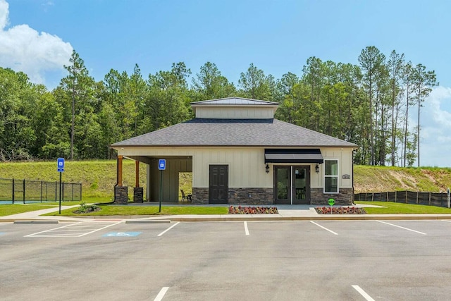 view of property with uncovered parking and fence