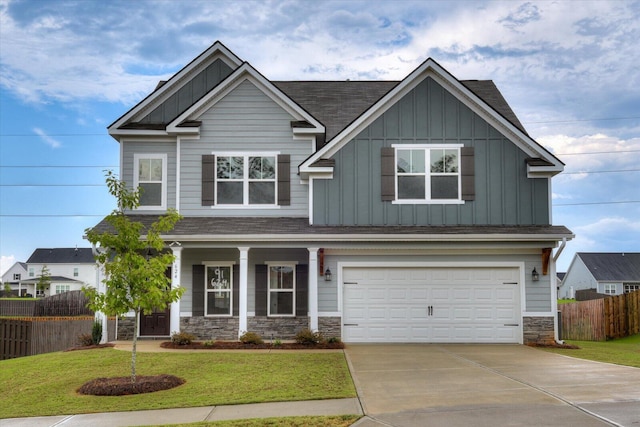 craftsman-style house featuring a front yard and a garage