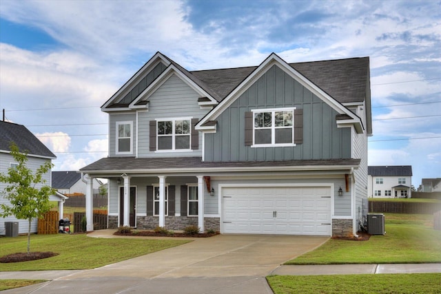 craftsman-style home featuring central AC, a front yard, and a garage