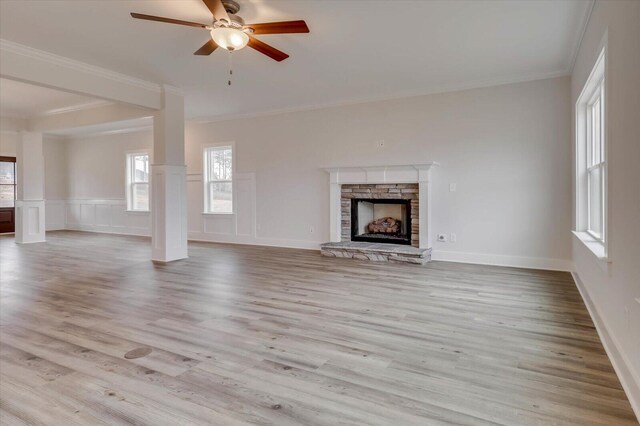 unfurnished living room featuring light hardwood / wood-style floors, ceiling fan, and crown molding