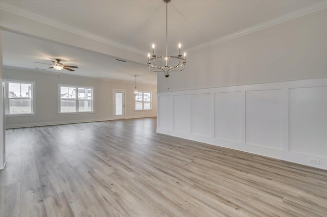 empty room featuring ceiling fan with notable chandelier, light hardwood / wood-style floors, and crown molding