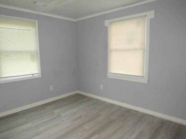 2629 Richmond Hill Rd, Augusta, GA 30906 - spare room with baseboards, visible vents, wood finished floors, and crown molding