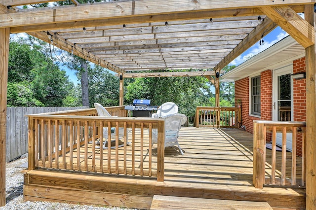141 Whaley St, Warrenville, SC 29851 - wooden deck featuring a pergola, grilling area, outdoor dining space, and view of scattered trees