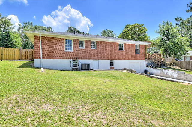 141 Whaley St, Warrenville, SC 29851 - rear view of house featuring brick siding, a garage, driveway, and stairway