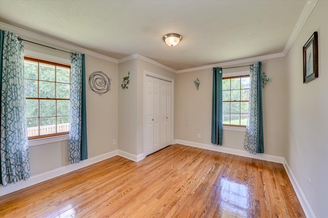 141 Whaley St, Warrenville, SC 29851 - unfurnished bedroom with light wood-style floors, a closet, and crown molding