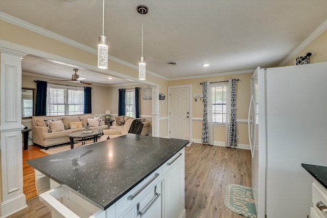 141 Whaley St, Warrenville, SC 29851 - kitchen with freestanding refrigerator, ornate columns, light wood-style floors, ornamental molding, and recessed lighting