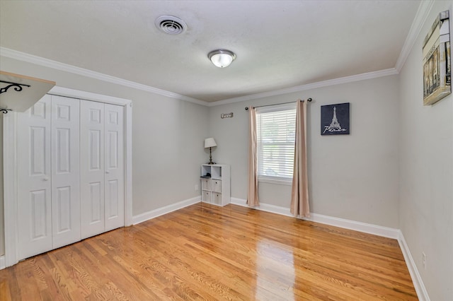 141 Whaley St, Warrenville, SC 29851 - unfurnished bedroom featuring light wood-type flooring, crown molding, and a closet