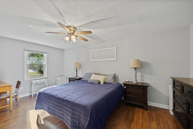 bedroom featuring a textured ceiling, ceiling fan, and dark hardwood / wood-style floors