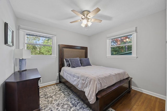 bedroom with hardwood / wood-style flooring and ceiling fan