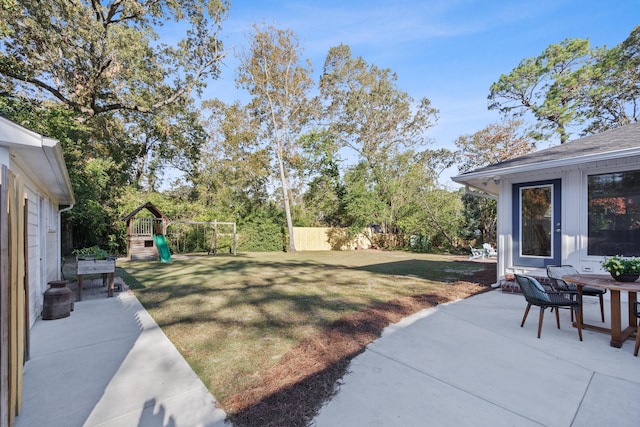 view of yard with a playground and a patio area