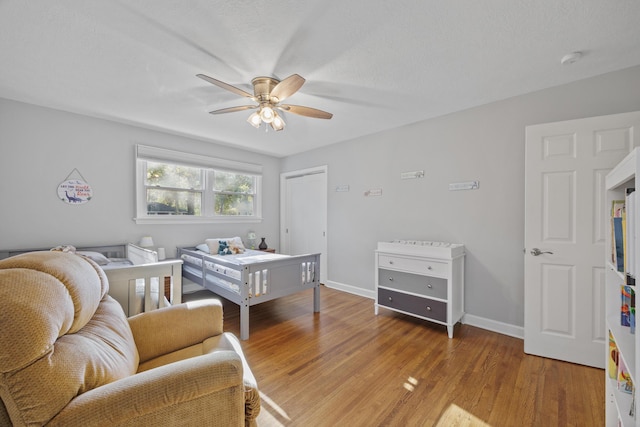 bedroom featuring hardwood / wood-style flooring and ceiling fan