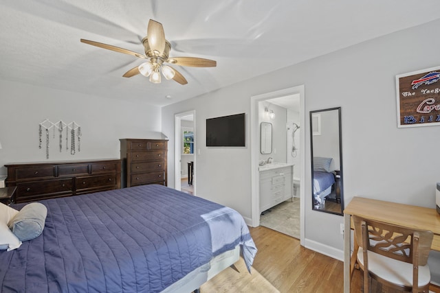 bedroom featuring connected bathroom, ceiling fan, and light wood-type flooring