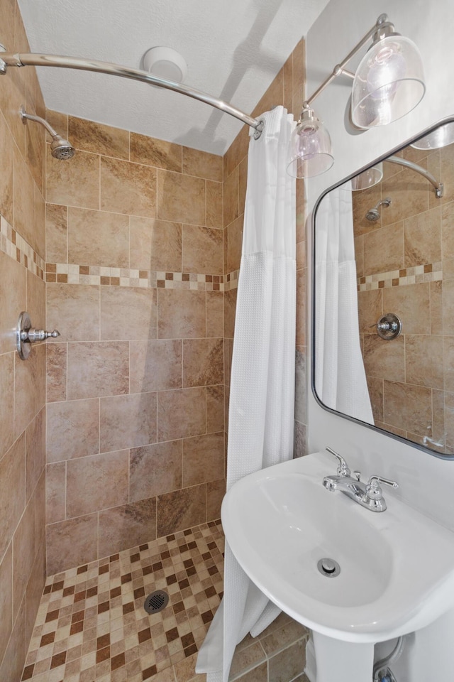 bathroom with walk in shower and sink