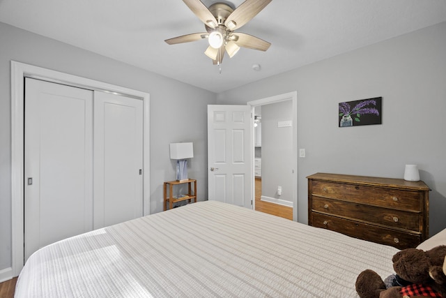 bedroom with ceiling fan, a closet, and hardwood / wood-style floors