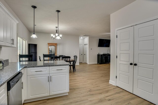 kitchen with stainless steel dishwasher, decorative light fixtures, white cabinetry, and light hardwood / wood-style flooring