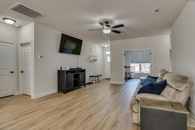 living room with ceiling fan and light hardwood / wood-style floors