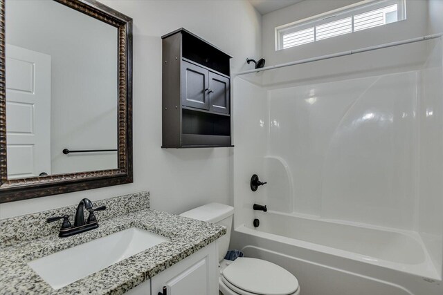 full bathroom featuring vanity,  shower combination, and toilet