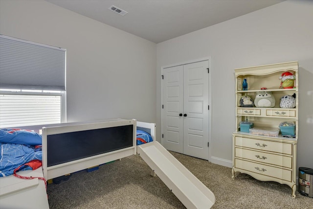 carpeted bedroom with a closet