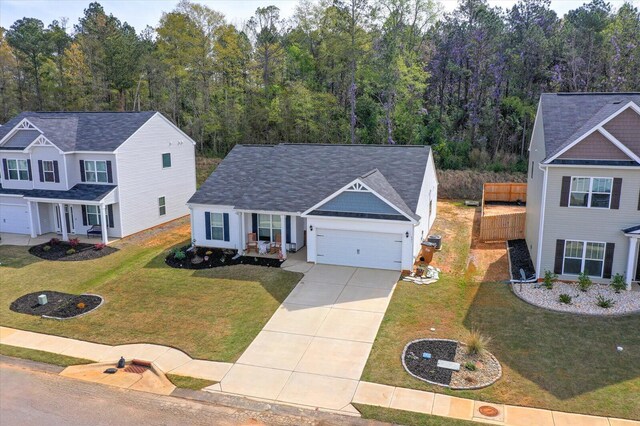 view of front of property with a front lawn and a garage