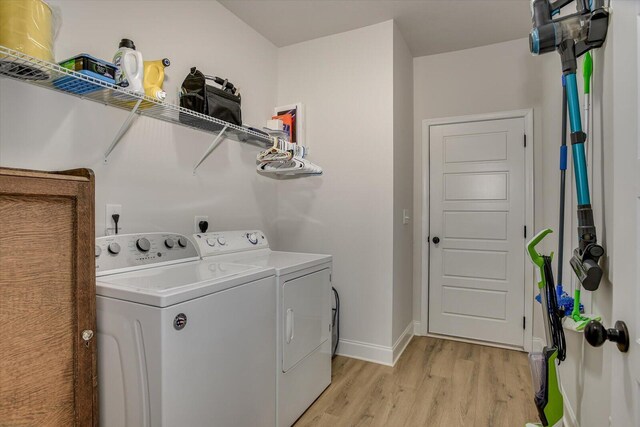 laundry room with light hardwood / wood-style floors and independent washer and dryer