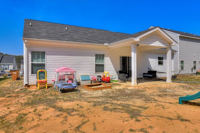 rear view of property featuring a patio