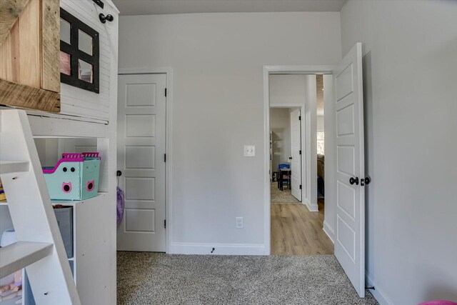 bedroom featuring light colored carpet