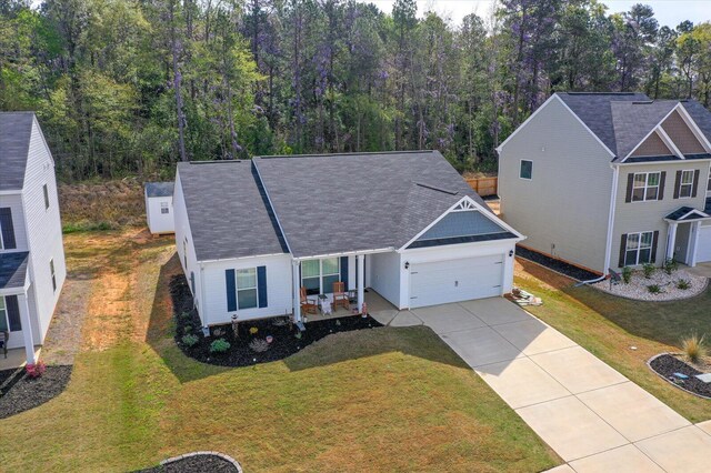 view of front of house with a garage and a front lawn