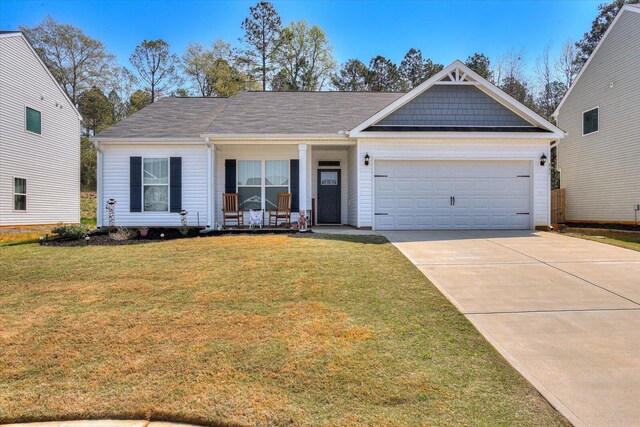 view of front facade with a porch, a garage, and a front lawn