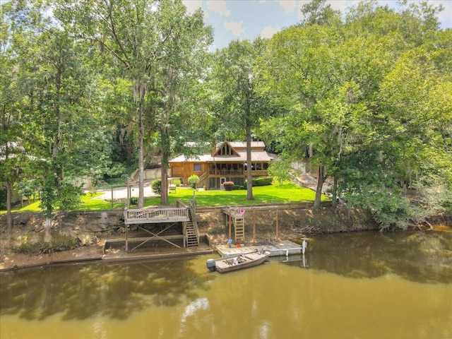 dock area with a deck with water view and a yard