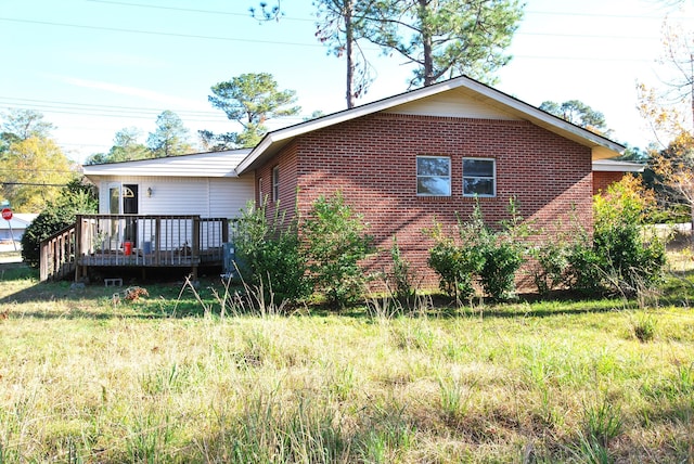 view of side of property with a deck