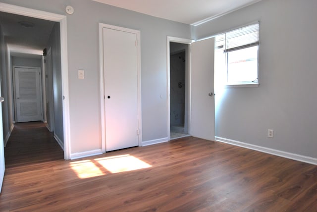 unfurnished bedroom featuring dark wood-type flooring