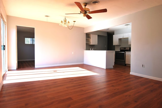 unfurnished living room featuring ceiling fan with notable chandelier and dark hardwood / wood-style floors