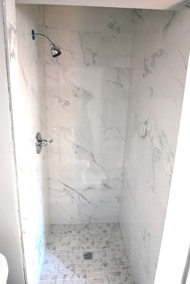 bathroom with tiled shower