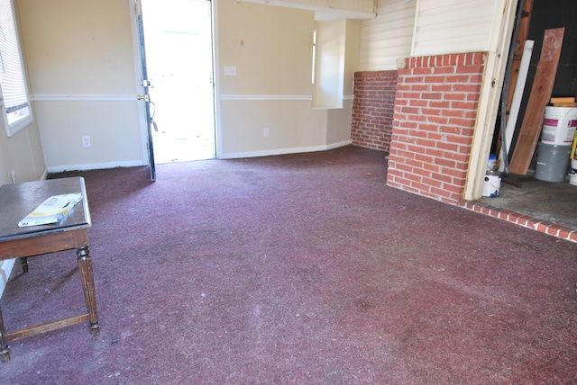 unfurnished living room featuring dark colored carpet