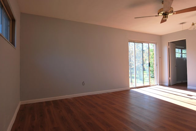 spare room featuring ceiling fan and dark hardwood / wood-style floors