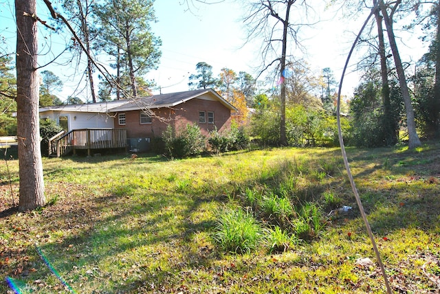 view of yard with a wooden deck