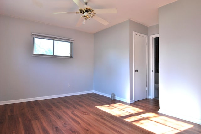 unfurnished room with dark hardwood / wood-style flooring and ceiling fan