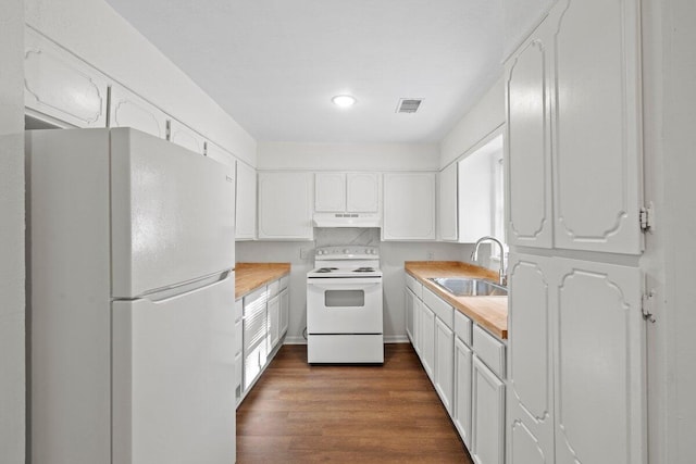 kitchen featuring white appliances, sink, dark hardwood / wood-style flooring, and white cabinets